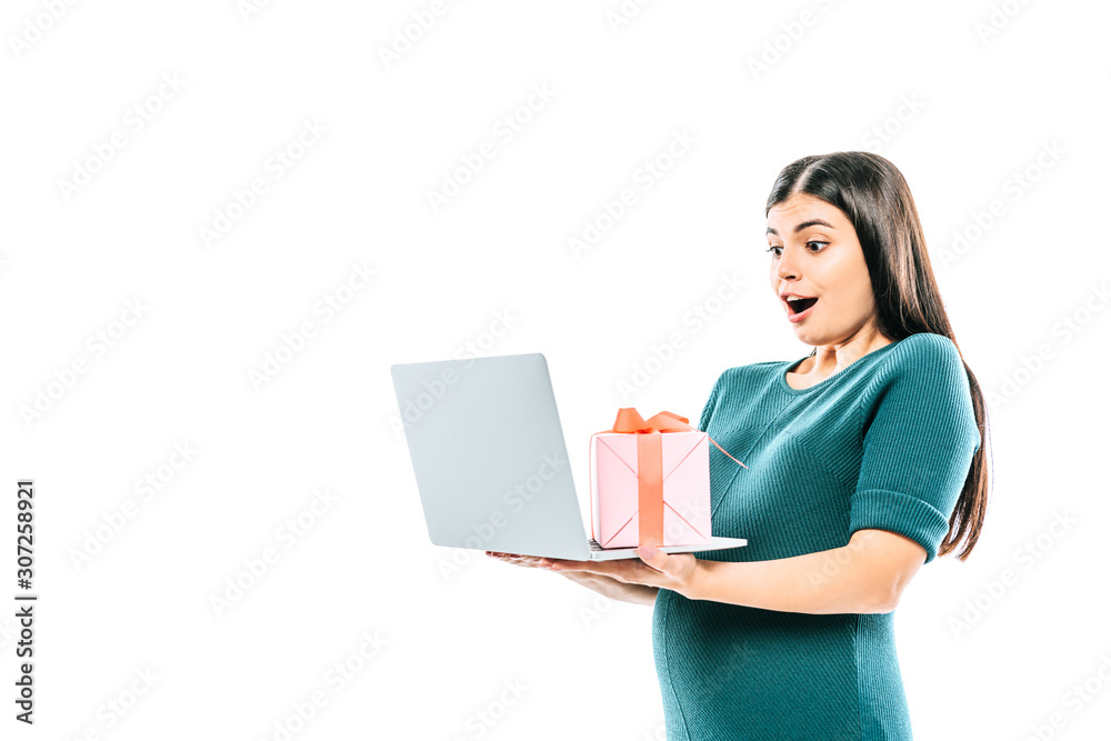 shocked pregnant girl holding laptop and gift isolated on white shocked pregnant girl holding laptop and gift isolated on white