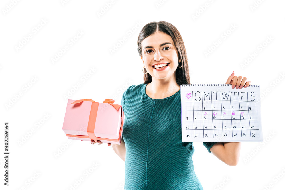 smiling pregnant girl holding present and period calendar isolated on white smiling pregnant girl holding present and period calendar isolated on white