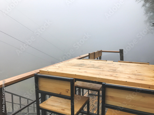 Table and a chair of the summer restorant in fog