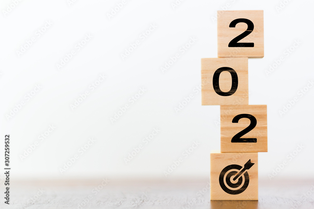 2020 on wooden cubes with goal target. New year´s sucess concept 2020 on wooden cubes with goal target. New year´s sucess concept