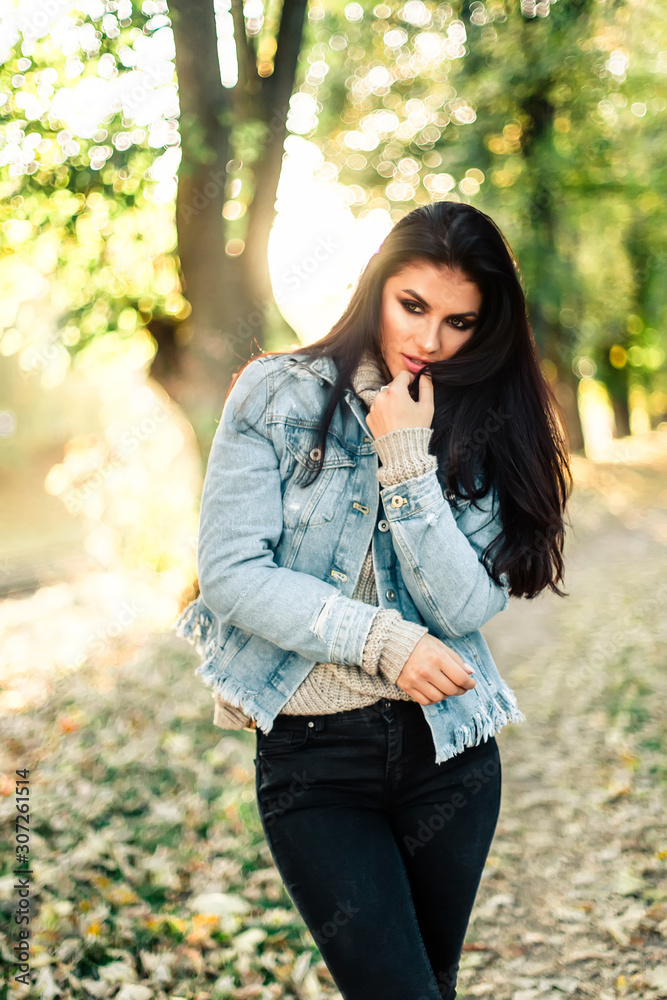 Beautiful model posing for the camera in the park. Beautiful model posing for the camera in the park.