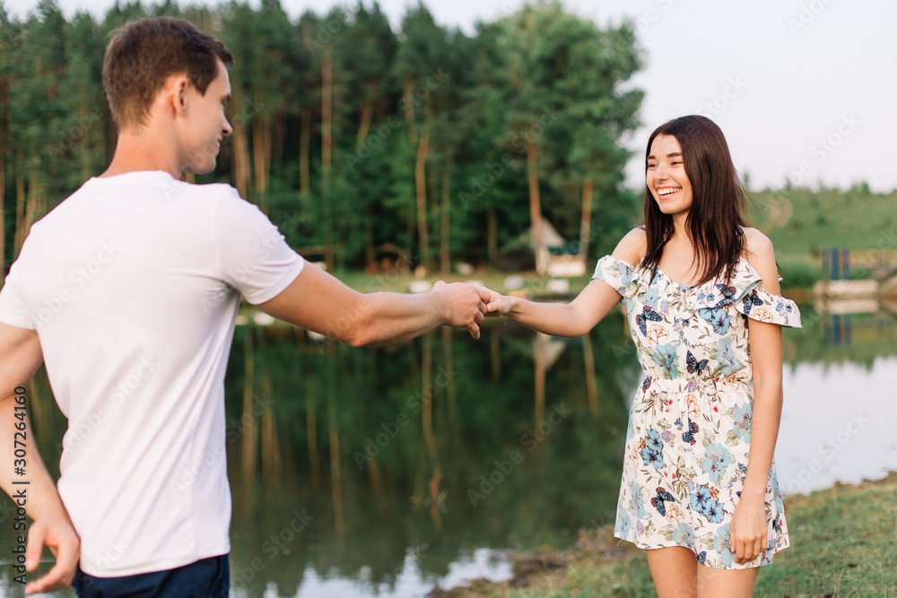 Young loving couple dancing near lake. Young loving couple dancing near lake.
