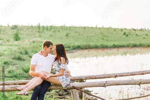 Portrait of happy couple outdoor in nature location at sunset.
