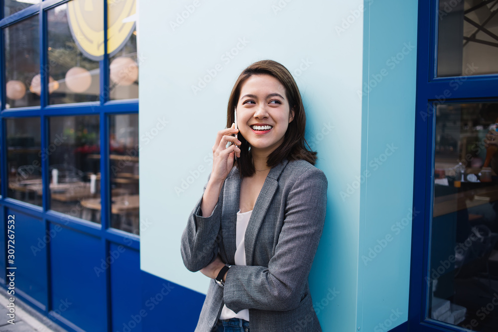 Confident ethic businesswoman smiling and talking on phone on street Confident ethic businesswoman smiling and talking on phone on street