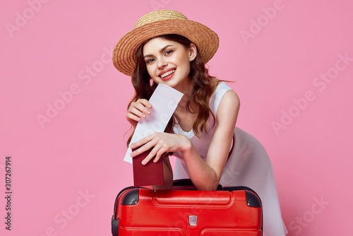 young woman with suitcase isolated on white