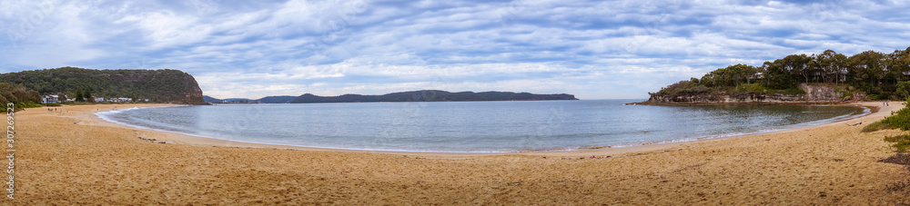 Panorama of tropical lagoon with sandy beach and mountains in the distance