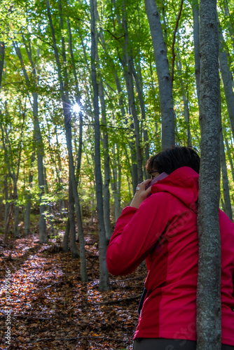 mature girl enjoys nature with her cell phone