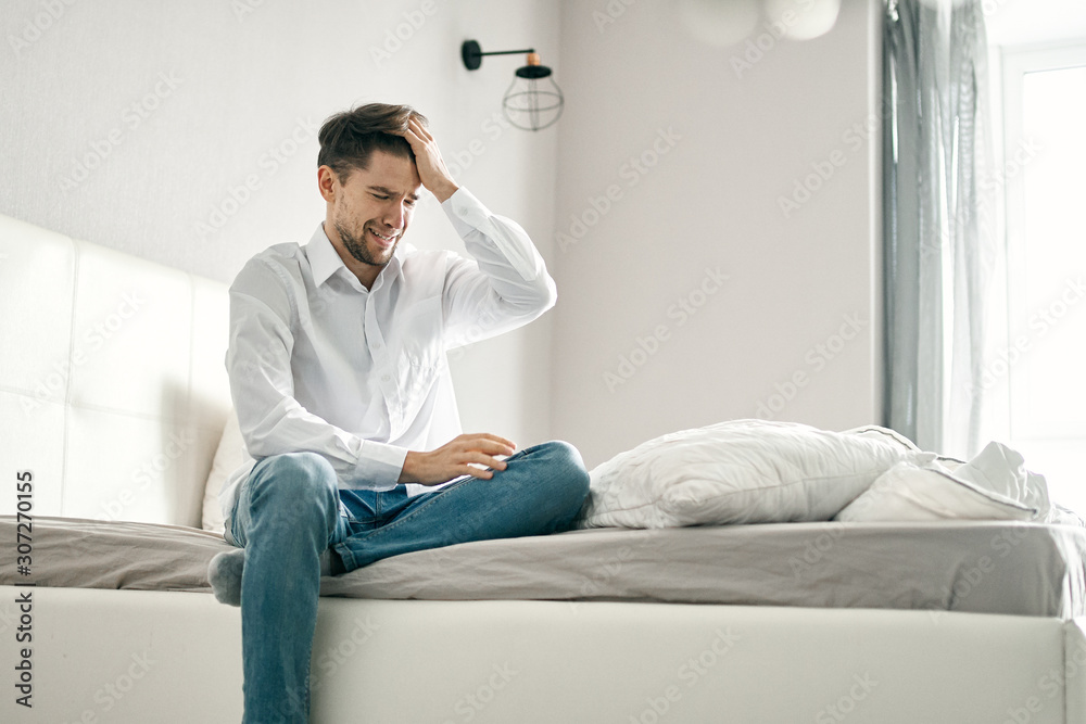 man sitting on sofa at home