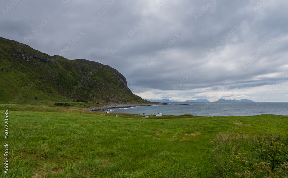 Countryside road to the sea in summer in Alnes, godoy island, Norway. July 2019. Countryside road to the sea in summer in Alnes, godoy island, Norway. July 2019.