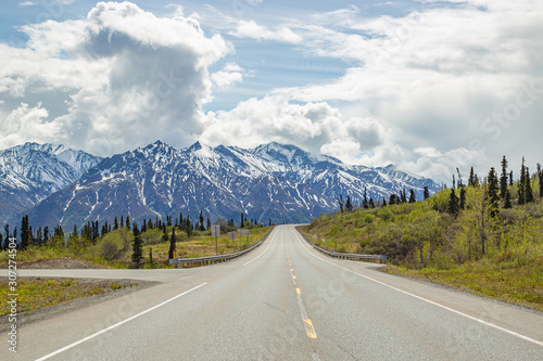 Scenic road heading toward mountains in Alaska