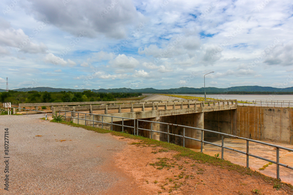 The dam crest the concrete spillway. countryside blocks the river to store water for agriculture and consumption