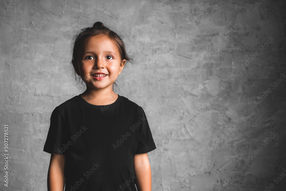 Little girl on a gray background. Portrait in beautiful colors Little girl on a gray background. Portrait in beautiful colors