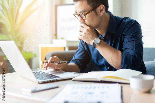 hand holding using texting cell phone and typing computer.businessman at workplace Thinking investment plan.chatting contact Investor.searching for information use internet.connecting people concept