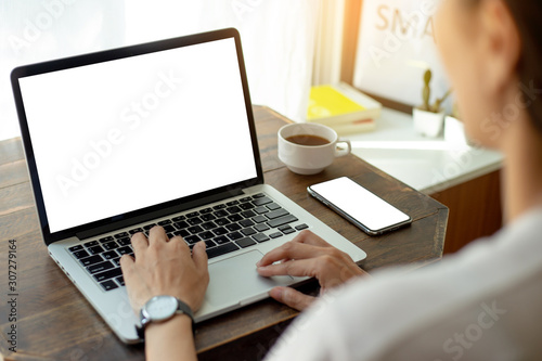 mockup image blank screen computer,cell phone with white background for advertising text,hand man using laptop texting mobile contact business search information on desk in office.marketing and design