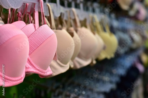 Row of bras in underwear shop blurred background , self confidence and health care concept.