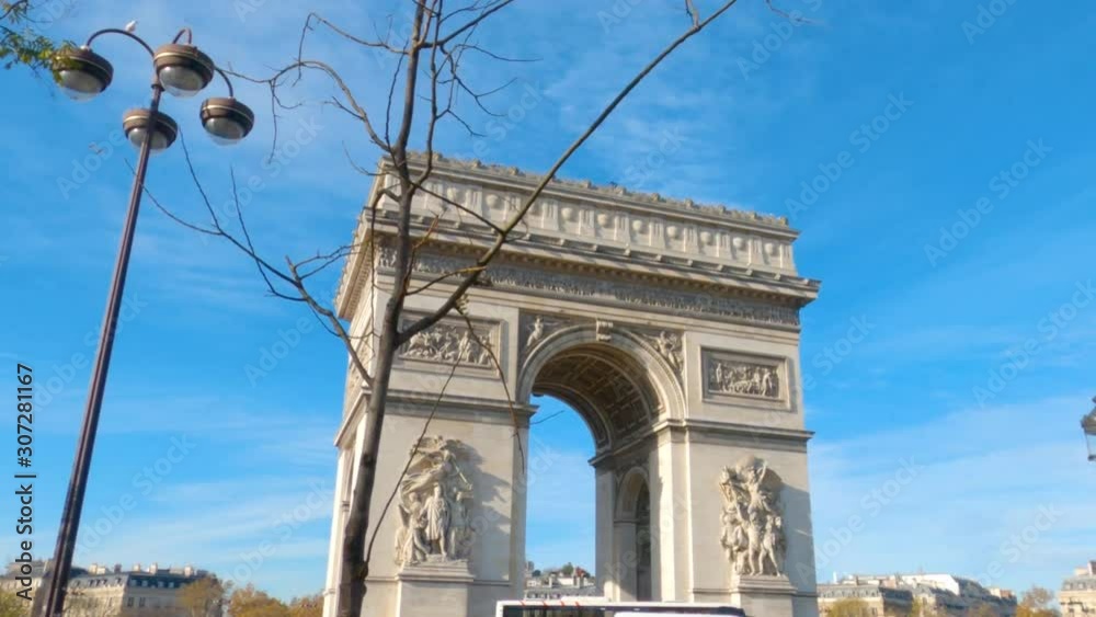 A walking handheld point of view shot of the Arc de Triomphe from the streets of Paris, France