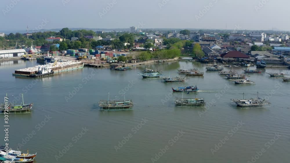 Tracking shot of a fishing boat sailing horizontally across a harbor Tracking shot of a fishing boat sailing horizontally across a harbor