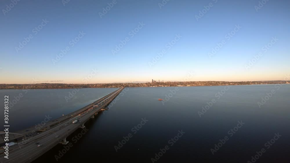 Dolly right above I-90 Floating Bridge above Lake Washington and Mercer Island facing Downtown Seattle at Sunrise Dolly right above I-90 Floating Bridge above Lake Washington and Mercer Island facing Downtown Seattle at Sunrise