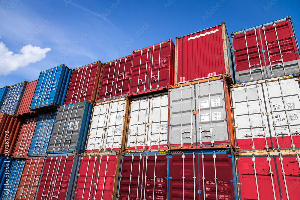 Fototapeta premium The national flag of Austria on a large number of metal containers for storing goods stacked in rows on top of each other. Conception of storage of goods by importers, exporters