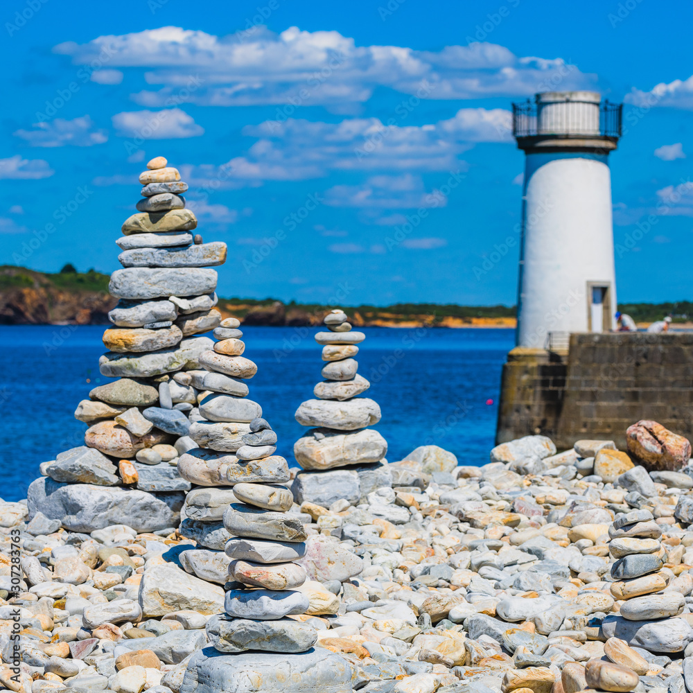 Landscape in Camaret-sur-Mer with stone towers in the foreground and lighthouse. Finister. Brittany. France Landscape in Camaret-sur-Mer with stone towers in the foreground and lighthouse. Finister. Brittany. France