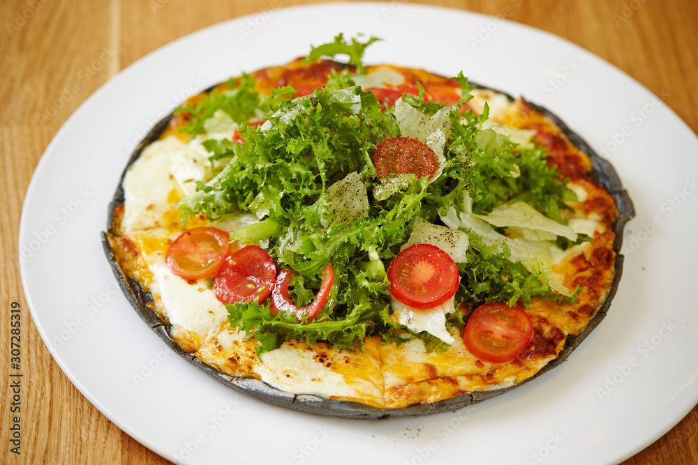 Black dough salad pizza with black pepper 