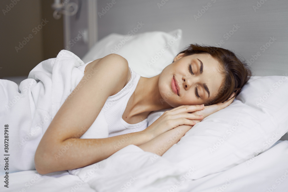 young woman sleeping in bed