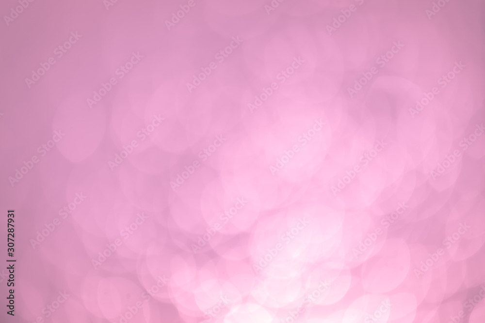 Pink Festive Christmas Beautiful abstract Background with bokeh lights. Holiday Texture with copy space. Can be used as Wallpaper, filling for a website, defocused