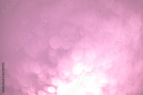 Pink Festive Christmas Beautiful abstract Background with bokeh lights. Holiday Texture with copy space. Can be used as Wallpaper, filling for a website, defocused