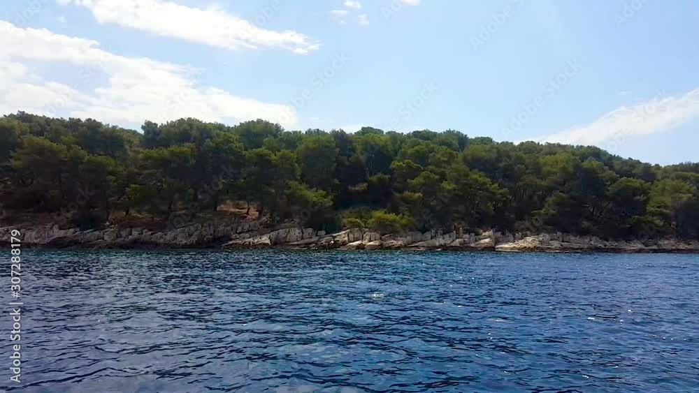 Cruising between islands by boat looking towards island in slow motion Cruising between islands by boat looking towards island in slow motion
