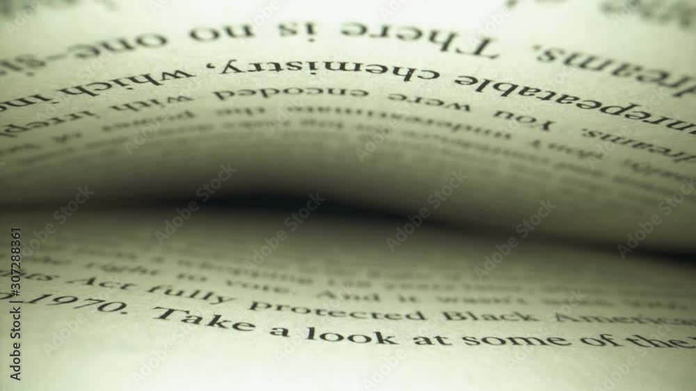 Unique perspective slider shot inside of a book as camera slowly backs out from the page. Macro probe lens. Unique perspective slider shot inside of a book as camera slowly backs out from the page. Macro probe lens.