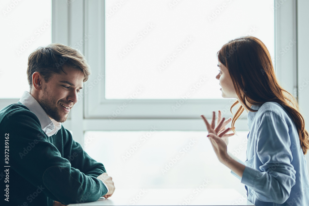 man and woman looking at screen