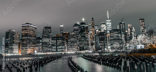Lower Manhattan financial disctrict with old pier pylons justting out of the water at night photo