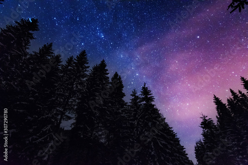 Great bright campsite with colorful tourist tents, on top in the Ukrainian Carpathian Mountains, at night with views of the stars and the Milky Way	