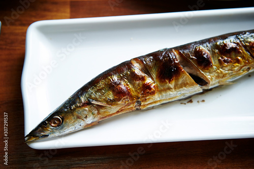 Grilled pacific saury fish on plate  photo