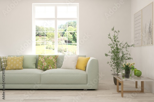 Stylish room in white color with sofa and summer landscape in window. Scandinavian interior design. 3D illustration