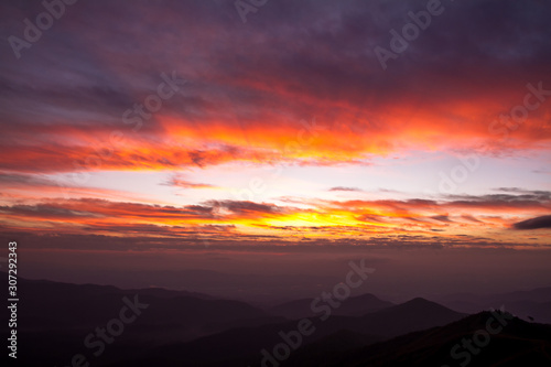 colorful clouds in sky on sunrise mountains