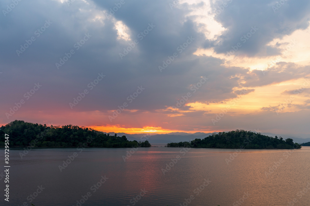 Obraz premium beautiful blue sky green forest mountains lake view at Kaeng Krachan National Park, Thailand. an idea for backpacker hiking on long weekend or a couple, family activity camping holiday relaxing