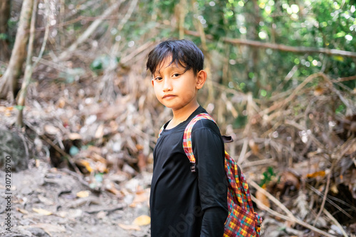 Semporna, Malaysia - November 26, 2019: kids in green forest, jungle trekking. concept of kids vacations and travel in Bohey Dulang Island. photo