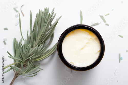 shea butter in brown glass pot and lavender leaves