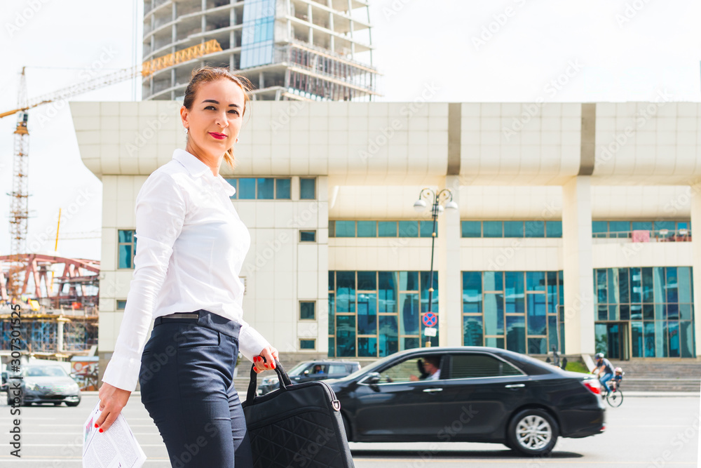 business woman with laptop walking down the street business woman with laptop walking down the street