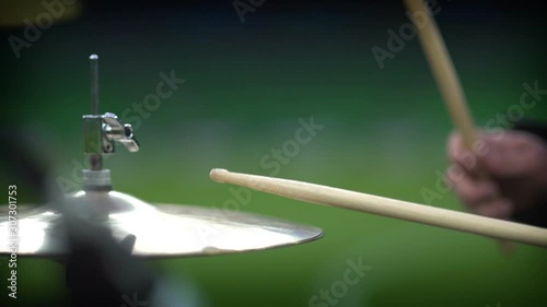 Close up footage of two drum sticks hitting drums and drum plates