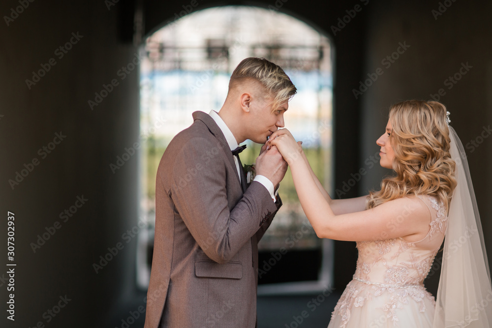 Fototapeta premium happy groom kisses the hand of the bride