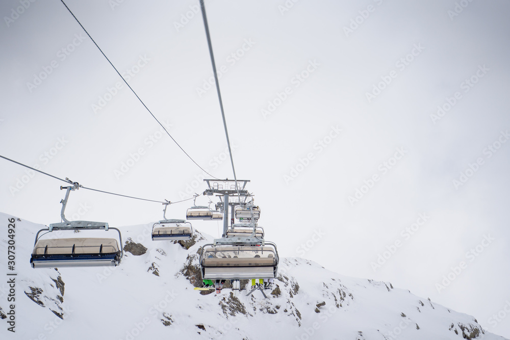 Photo of cableway among snowy hills Photo of cableway among snowy hills