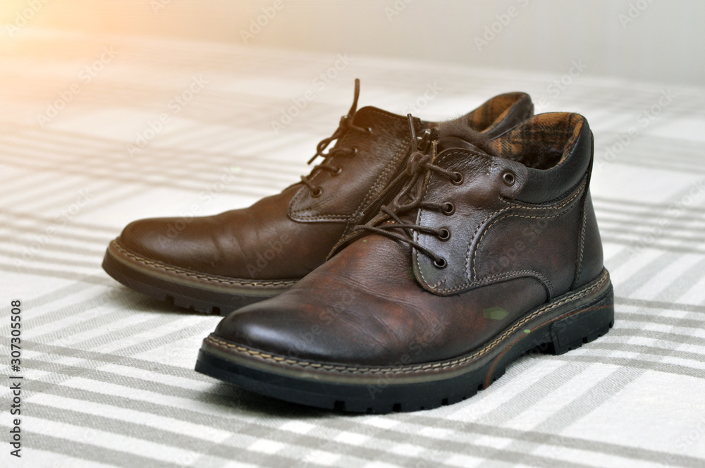 Men's insulated brown shoes made of genuine leather and with fur with lacing. Men's insulated brown shoes made of genuine leather and with fur with lacing.