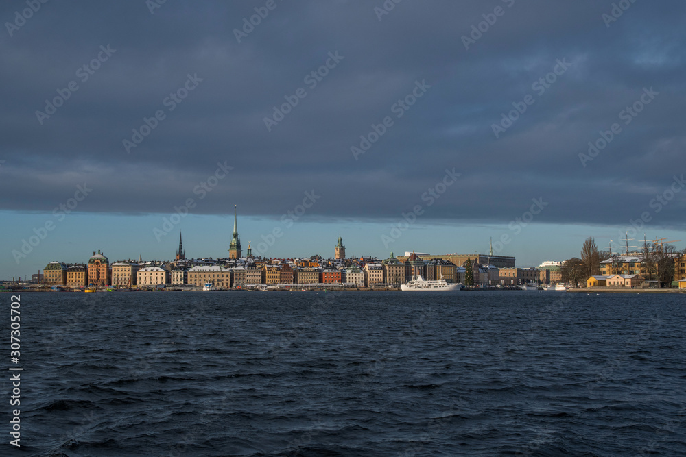 Water view over Stockholm inner harbour an winter day in pale light