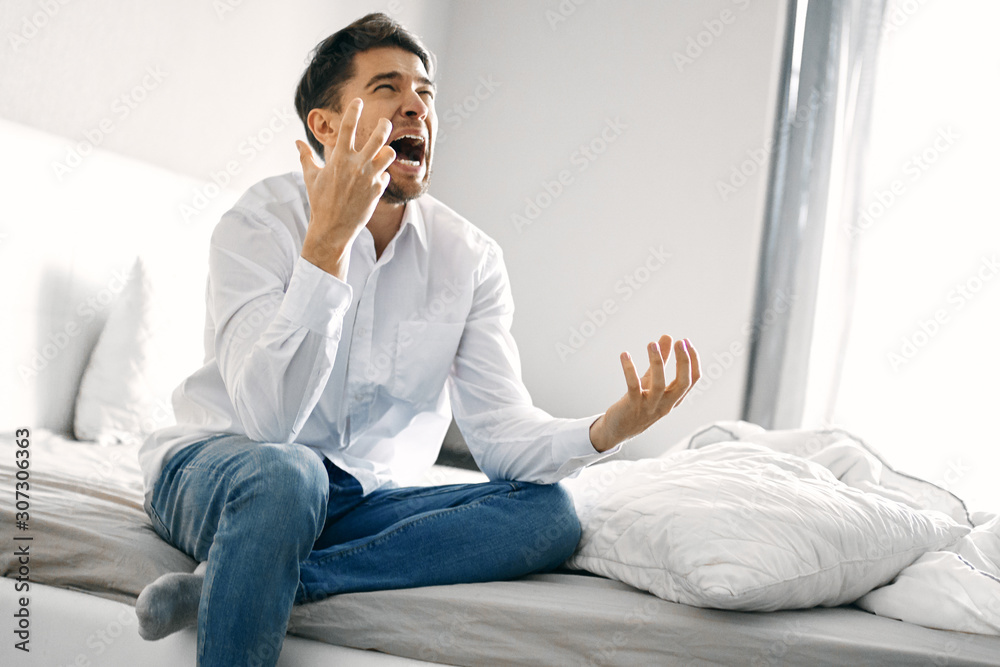 man sitting on sofa and talking on cell phone man sitting on sofa and talking on cell phone