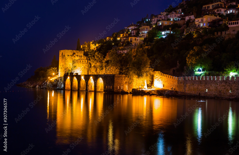 Fototapeta premium Night view of harbour, fortress and ancient shipyard in Alanya, Turkey