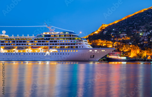 Beautiful white giant luxury cruise ship on stay at Alanya harbor photo