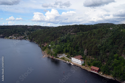 Typical Swedish nature and houses on the shore of the fjord. View from the high bridge over the fjord. The border of Norway and Sweden.Near the town Selater,Sweden © Sergey Kamshylin