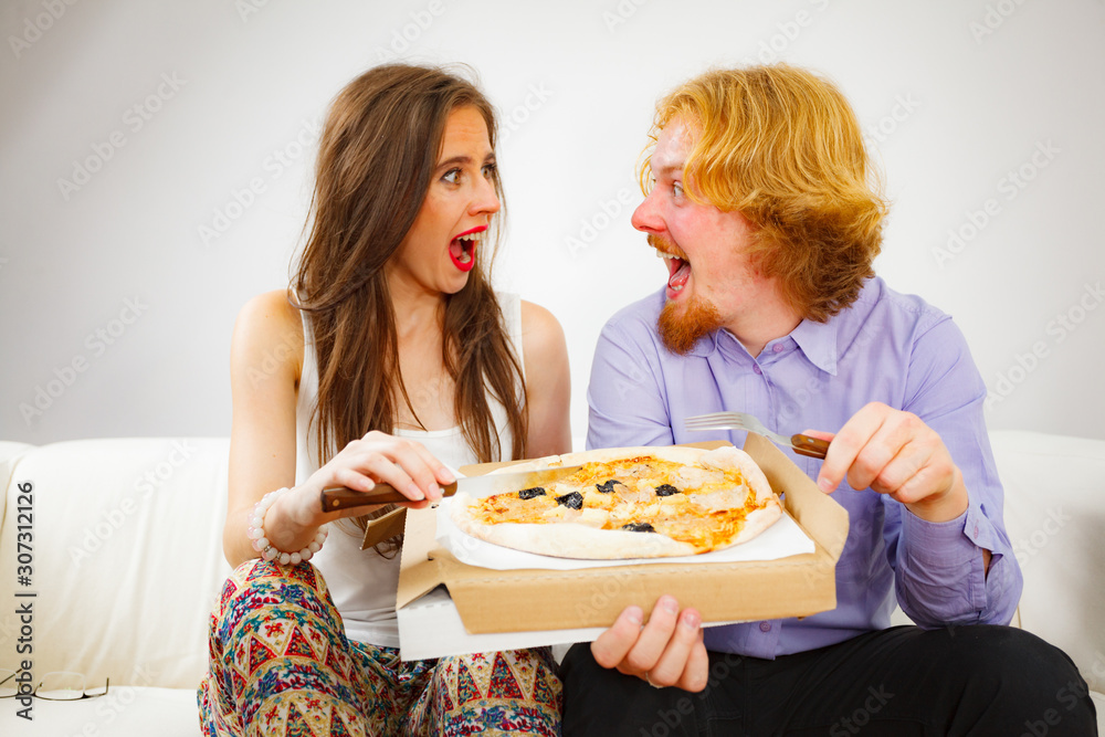 Couple eating pizza